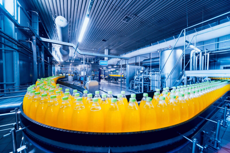 Conveyor with bottles for juice or water representing the use of Fabricote products in industrial situations.